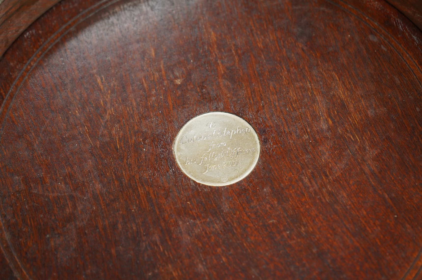 An Elizabeth II large silver mounted decanter coaster, maker W.E.V., London, 2000, with presentation inscription to central boss, diameter 25.6cm.